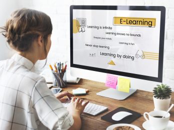 Woman using working on computer screen on wooden table